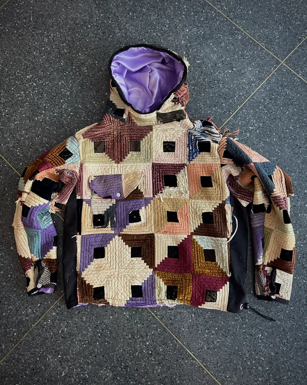 Flat lay of the rose log cabin hoodie, hood open to show lavender satin lining